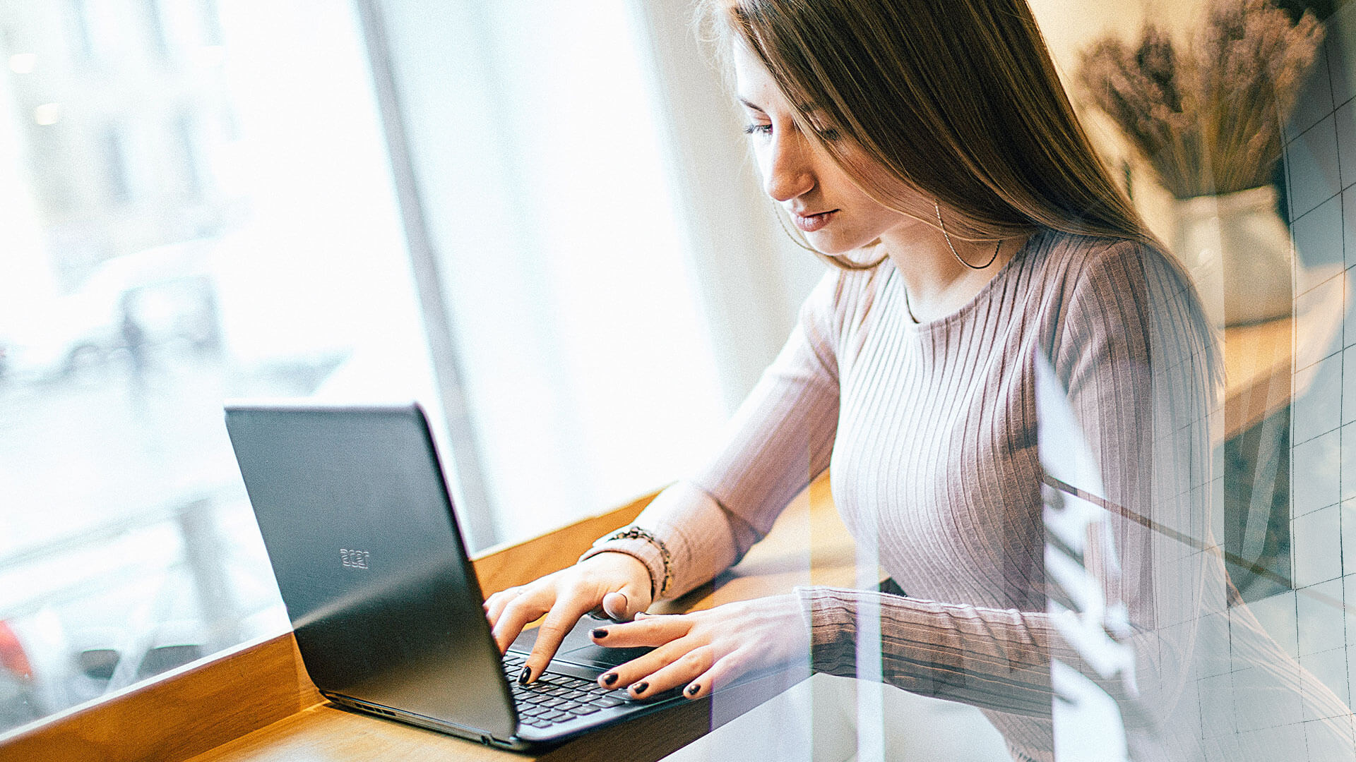 Business owner reviewing her company's weekly numbers on a laptop